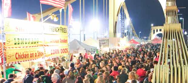 people gathering on the bridge for Light Up Night